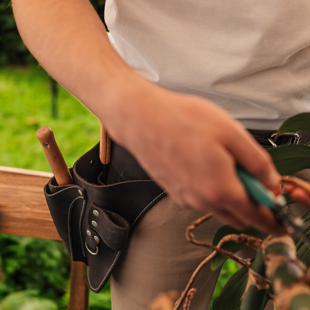 Gardener wearing FloraFit leather garden tool belt