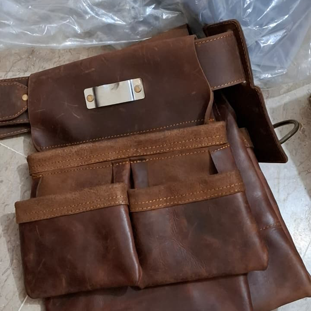 Brown leather bag with metal clasp on a tiled floor