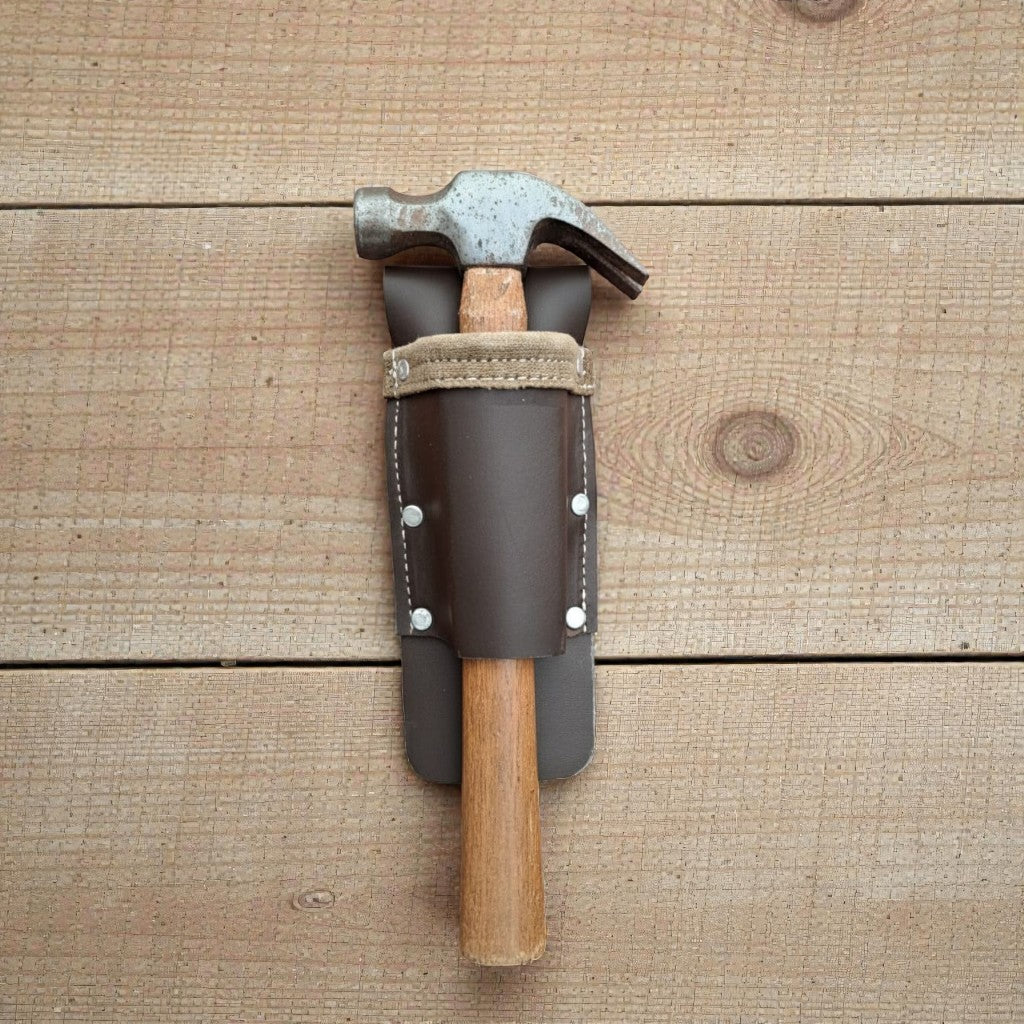 Hammer with leather sheath on a wooden surface